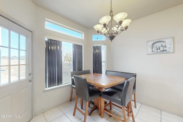 tiled dining space featuring a healthy amount of sunlight and a chandelier