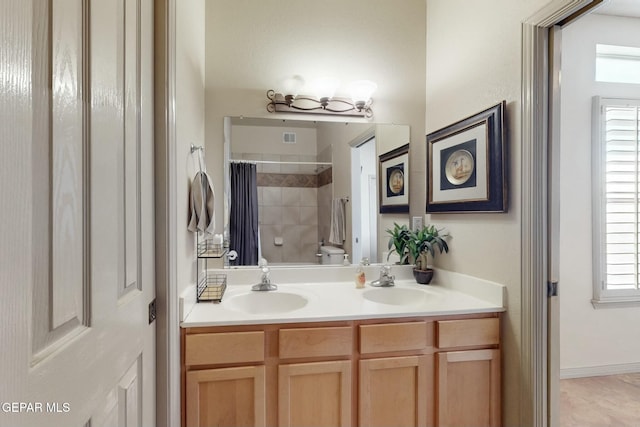 bathroom with vanity, curtained shower, and toilet