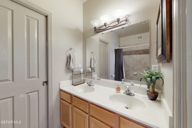 bathroom featuring double vanity, a sink, visible vents, and shower / tub combo with curtain