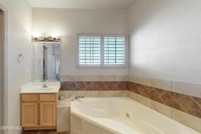 bathroom with a jetted tub and vanity