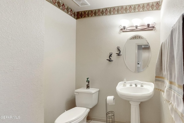 bathroom featuring toilet and visible vents