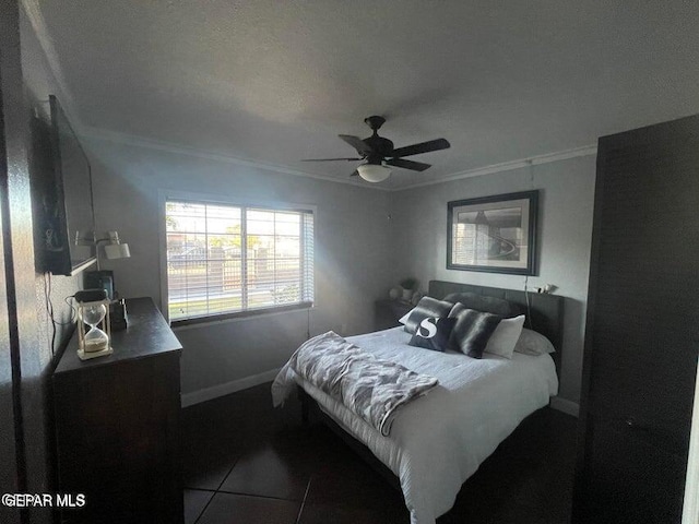 bedroom featuring tile patterned floors, ornamental molding, and ceiling fan