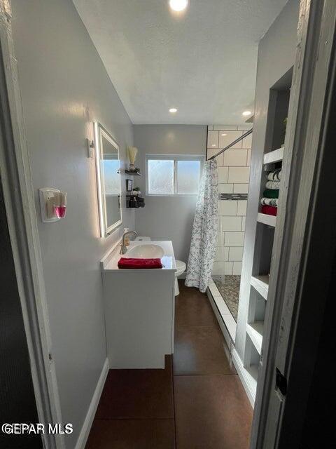 bathroom with tile patterned floors, vanity, toilet, and a shower with shower curtain