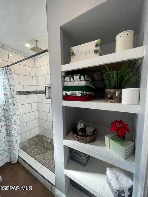 bathroom featuring curtained shower and wood-type flooring