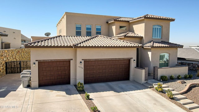 view of front of house with a garage, concrete driveway, and stucco siding