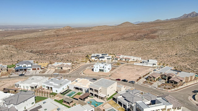 drone / aerial view with a residential view, a mountain view, and a desert view