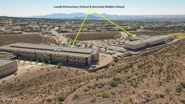 birds eye view of property with a mountain view