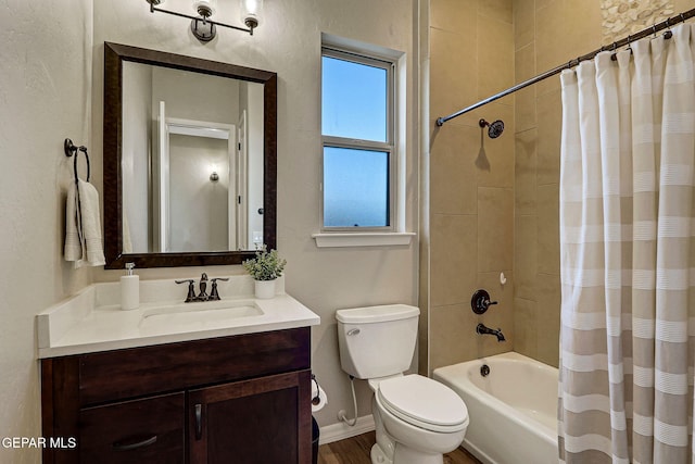 bathroom with vanity, shower / tub combo, toilet, and baseboards