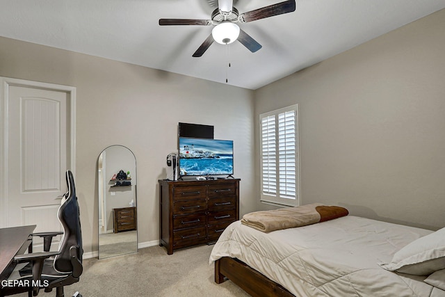 bedroom with light colored carpet, a ceiling fan, and baseboards