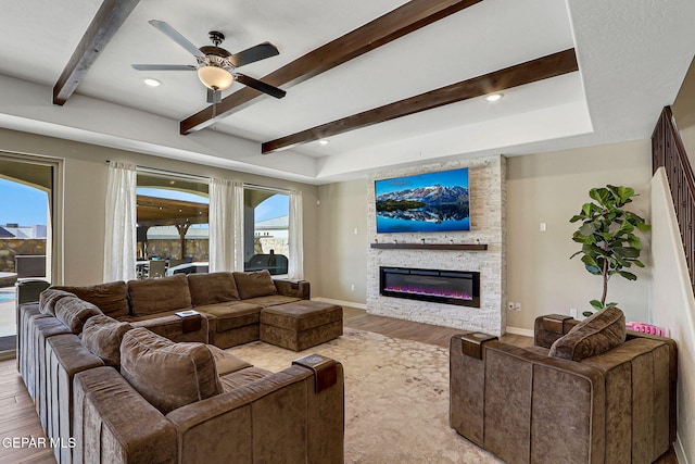 living room with beam ceiling, baseboards, light wood-style floors, and a ceiling fan