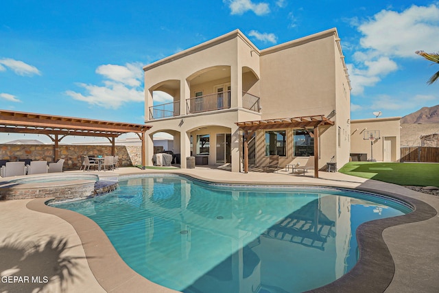 view of pool with fence, a pool with connected hot tub, a pergola, and a patio area