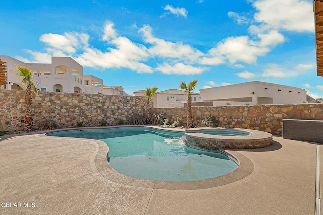 view of pool featuring a patio area, a fenced backyard, and a pool with connected hot tub