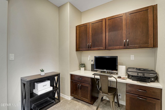 office area with baseboards and built in study area