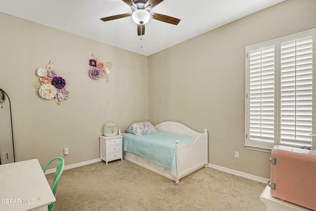 bedroom with baseboards, a ceiling fan, and carpet flooring