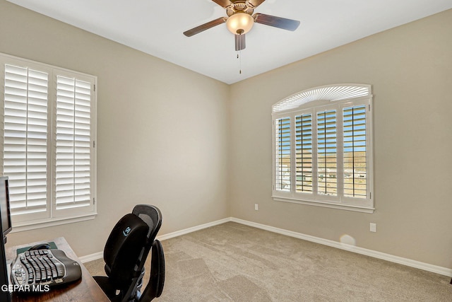 home office featuring baseboards, ceiling fan, and carpet floors