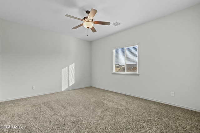 spare room featuring carpet floors and ceiling fan