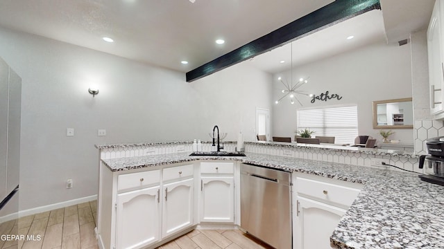 kitchen with dishwasher, sink, white cabinets, and kitchen peninsula