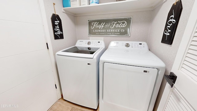 washroom featuring washer and clothes dryer