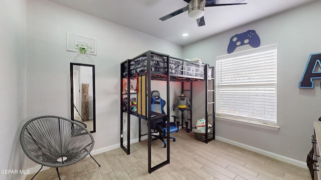 bedroom with ceiling fan and light hardwood / wood-style flooring