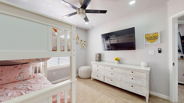 bedroom with light hardwood / wood-style floors and ceiling fan