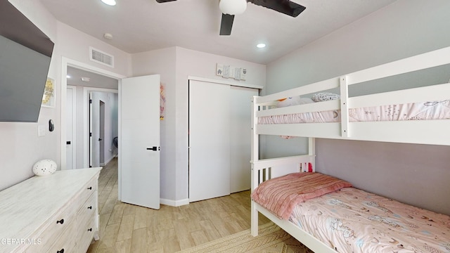 bedroom with ceiling fan, light wood-type flooring, and a closet