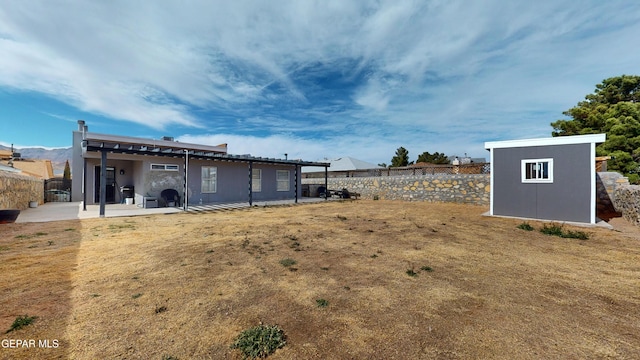 view of yard with a storage shed and a patio area