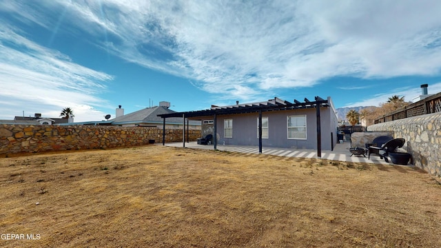 back of house with a yard and a patio