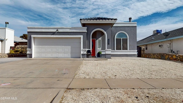 mediterranean / spanish-style home with a garage