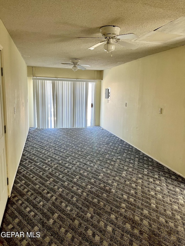 carpeted empty room with a textured ceiling