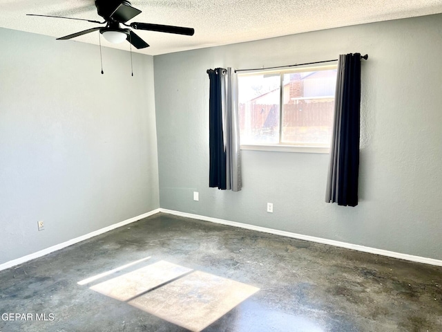 unfurnished room featuring ceiling fan and a textured ceiling