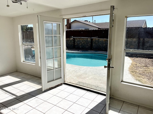 doorway featuring light tile patterned flooring and a wealth of natural light