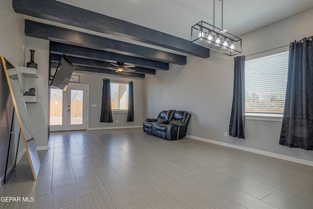 unfurnished room with beam ceiling, french doors, and ceiling fan