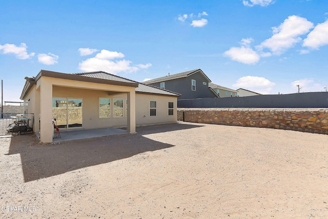 back of property with a patio