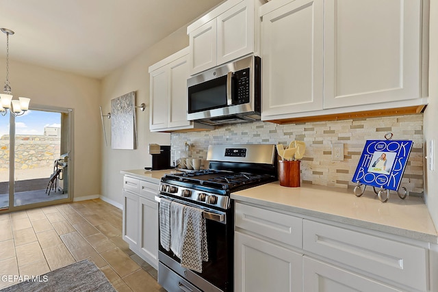 kitchen with stainless steel appliances, white cabinetry, tasteful backsplash, and pendant lighting