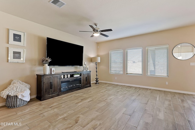 living room featuring light wood-type flooring and ceiling fan