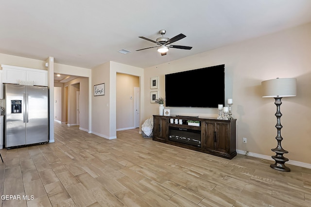 unfurnished living room featuring ceiling fan and light hardwood / wood-style floors