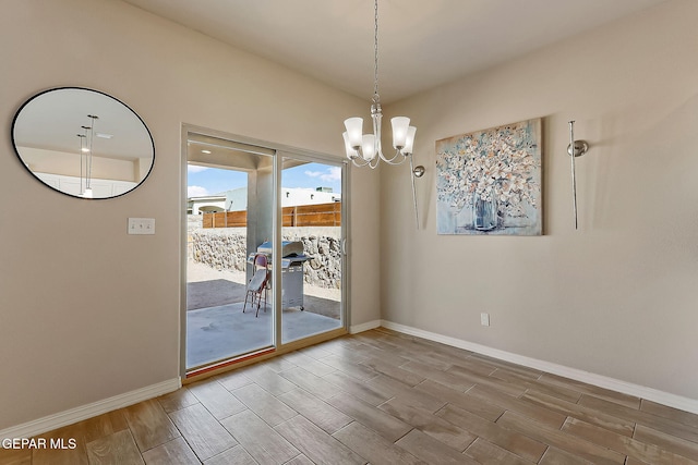 unfurnished dining area featuring an inviting chandelier