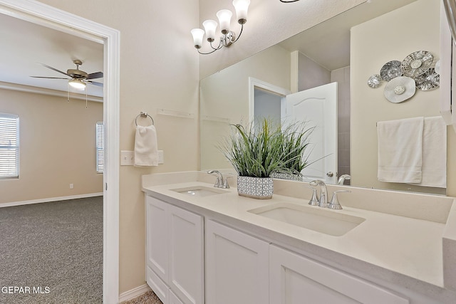 bathroom with vanity and ceiling fan with notable chandelier