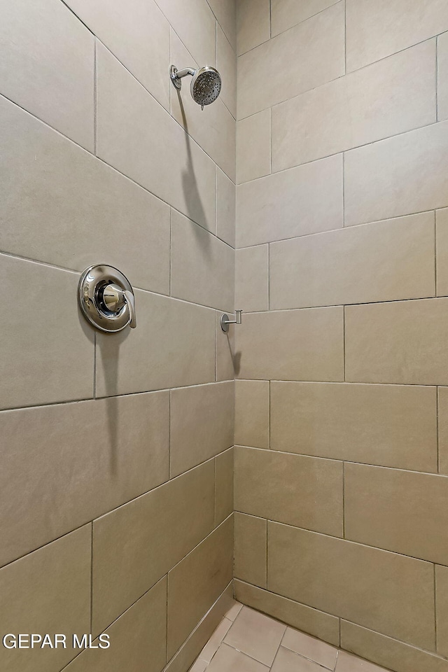 bathroom with tiled shower