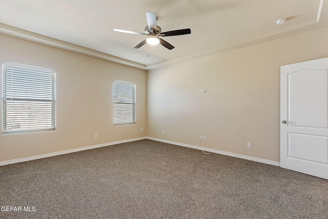 carpeted spare room featuring ceiling fan