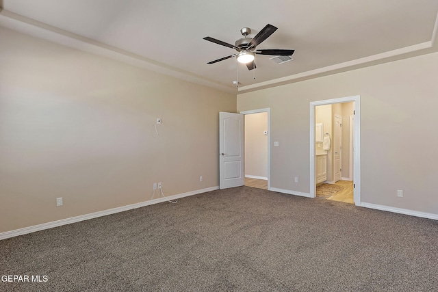 unfurnished bedroom featuring connected bathroom and light carpet