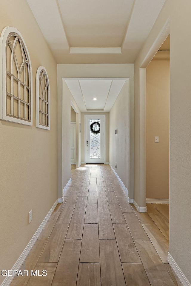 hall with a tray ceiling