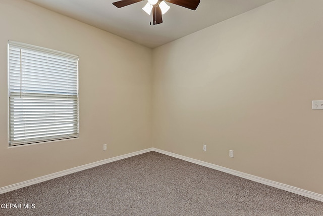 carpeted spare room with ceiling fan