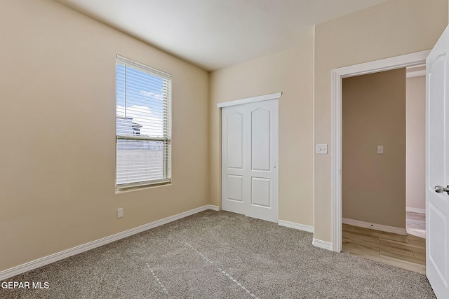 unfurnished bedroom featuring carpet flooring and a closet