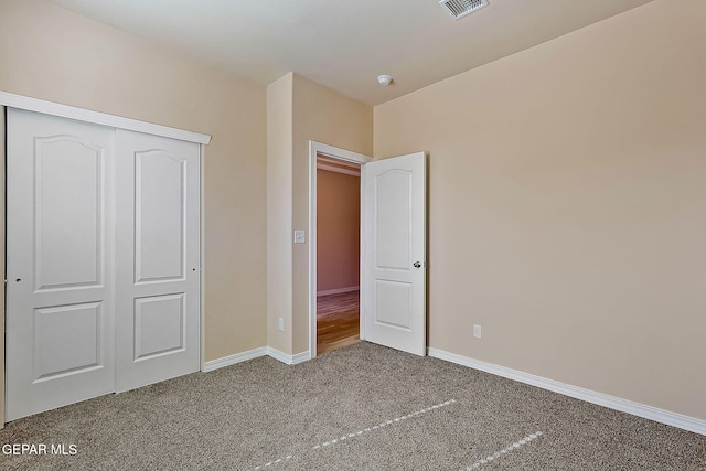 unfurnished bedroom featuring a closet and carpet