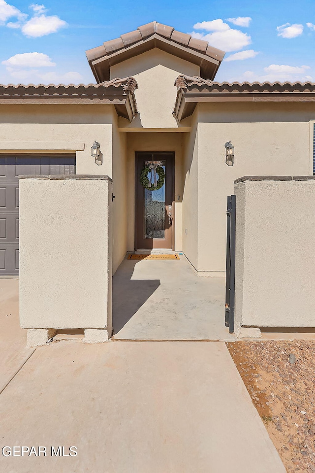 view of exterior entry with a garage