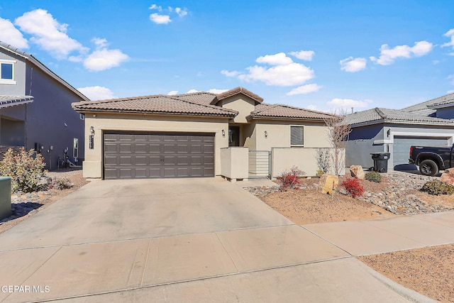 mediterranean / spanish-style home with a garage