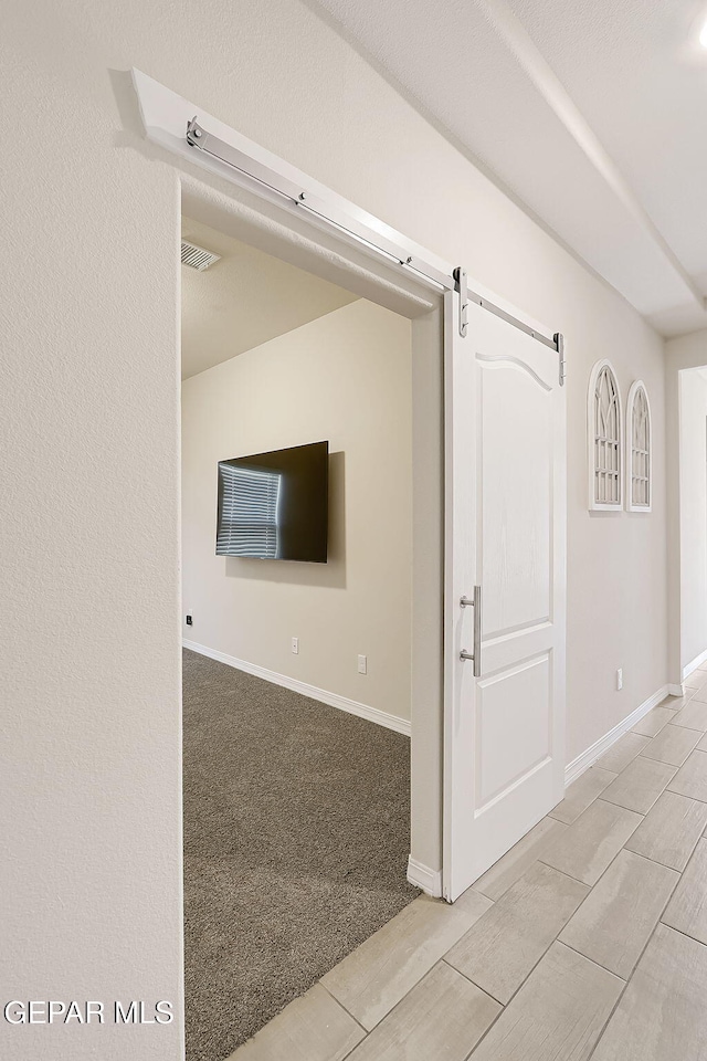 interior space featuring a barn door