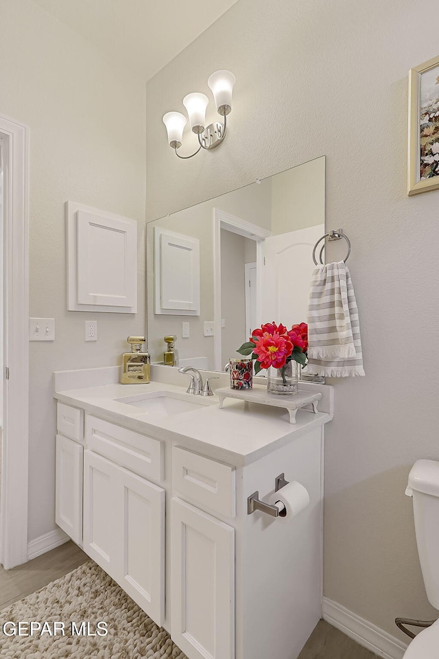 bathroom featuring vanity and toilet