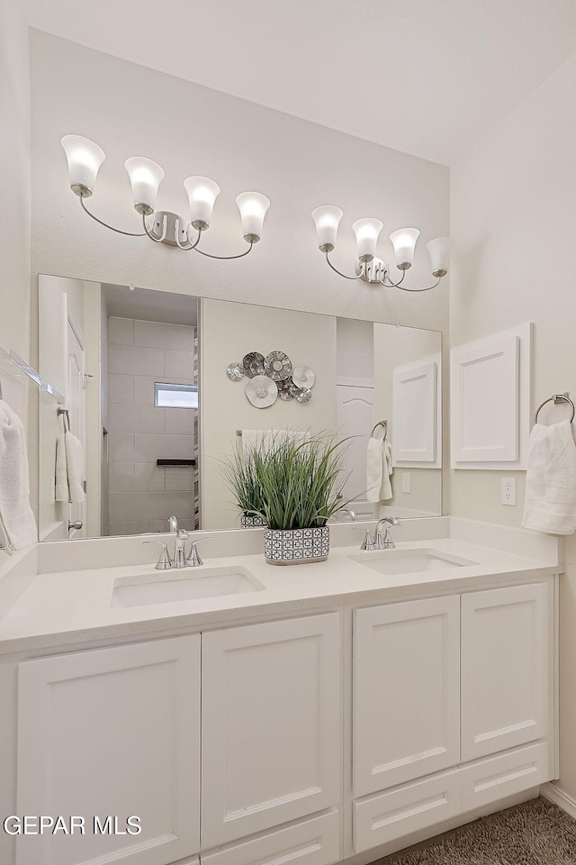 bathroom featuring vanity and tiled shower